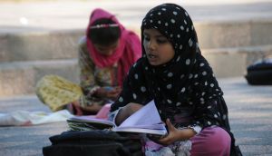 Underprevileged Pakistani children study in an open space at...