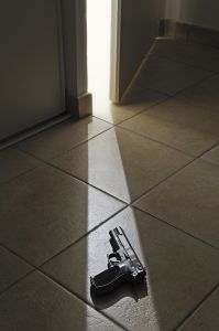 Light rays on Handgun from doorway left ajar