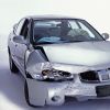 Silver sedan with front end damage and deployed airbags