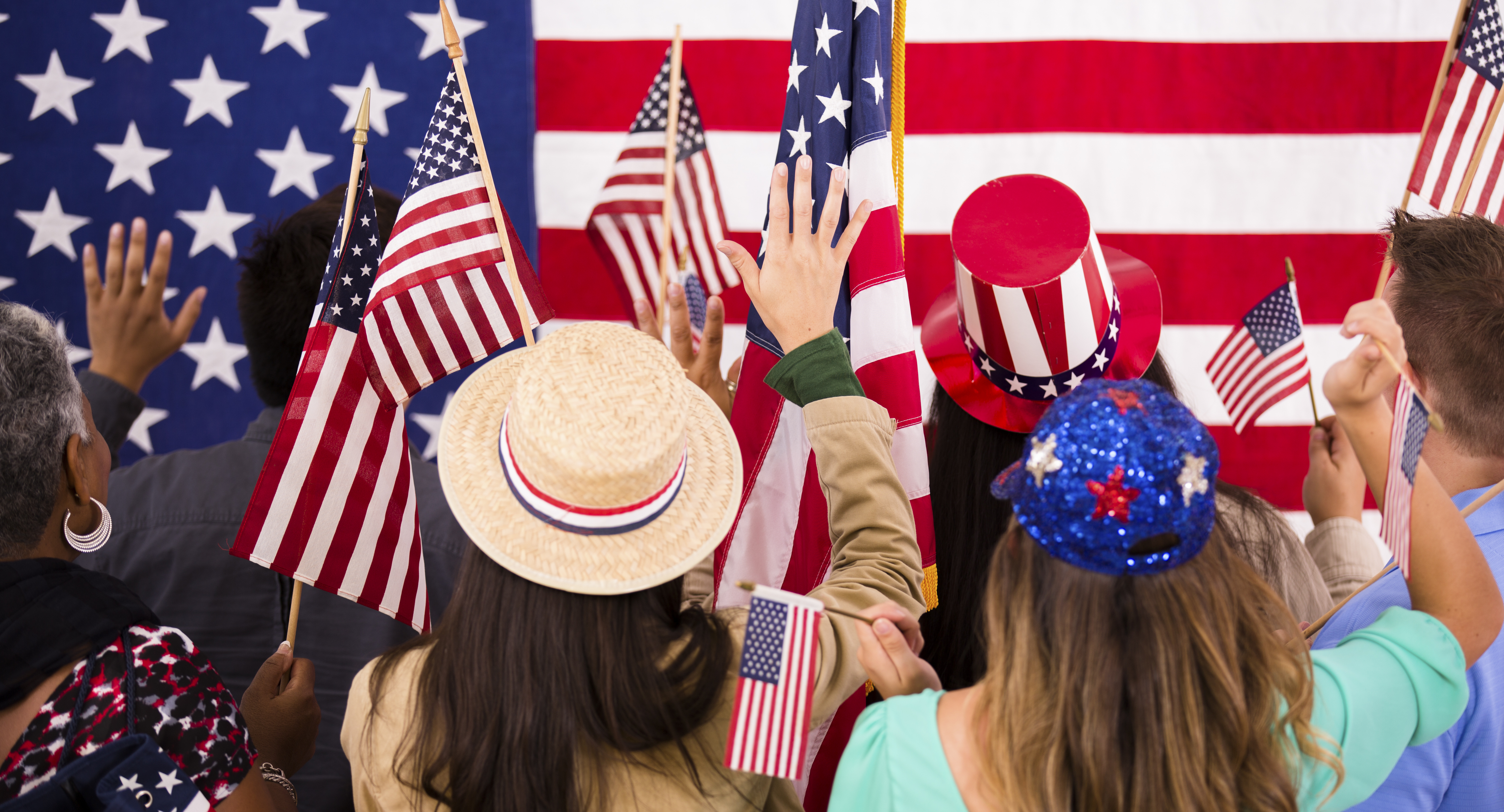 American people wave flags at political rally. USA.