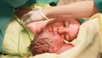 Mother looking at newborn after parturition