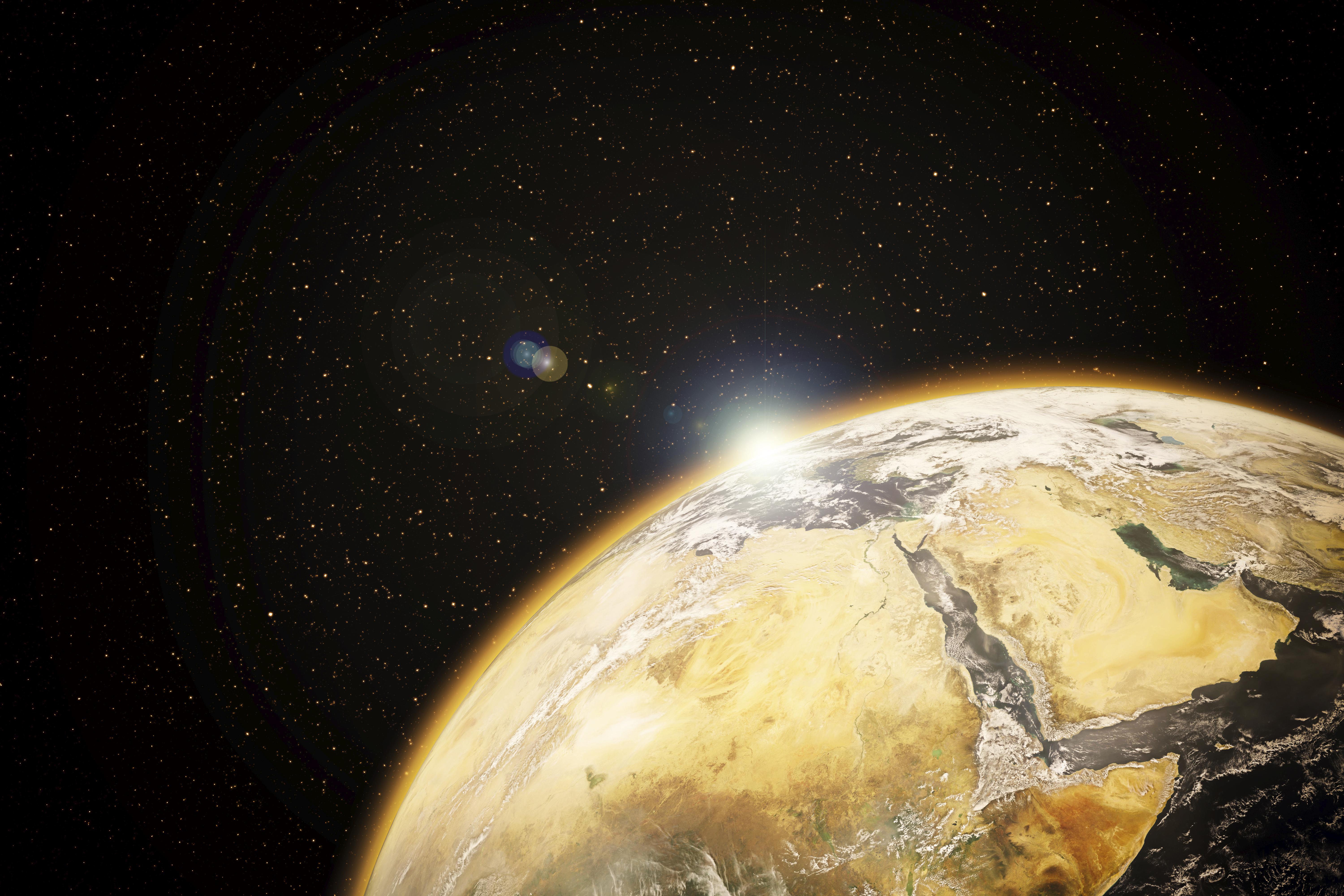 Rising sun behind planet