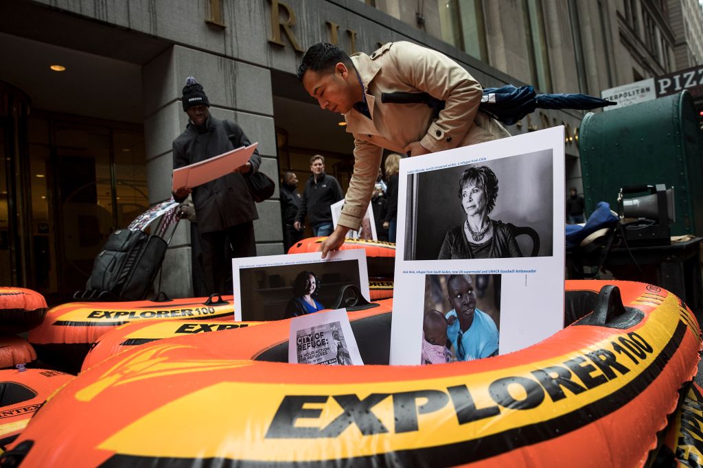 Protestors Rally Against Immigration Ban On Wall Street