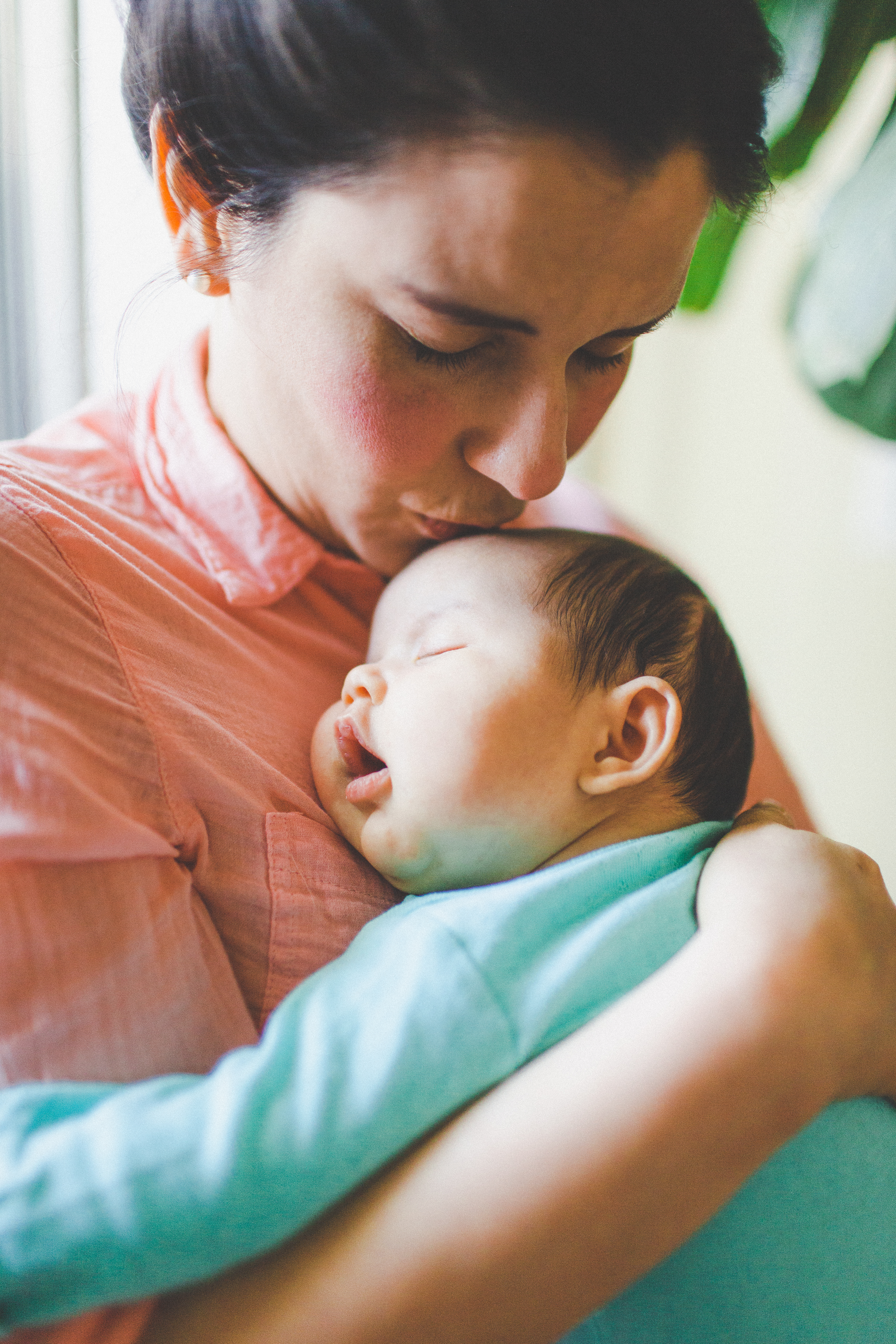 Baby sleeping in mothers arms