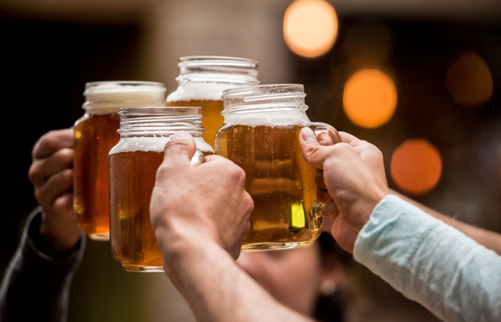 Close-up on a group of friends making a toast at a restaurant