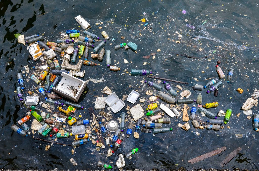 Floating plastic and styrofoam trash polluting a corner of...