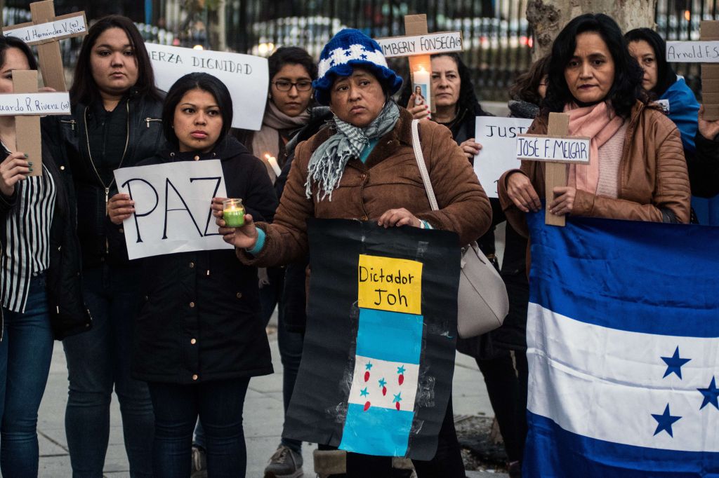 The Honduran community in Madrid marching against President...