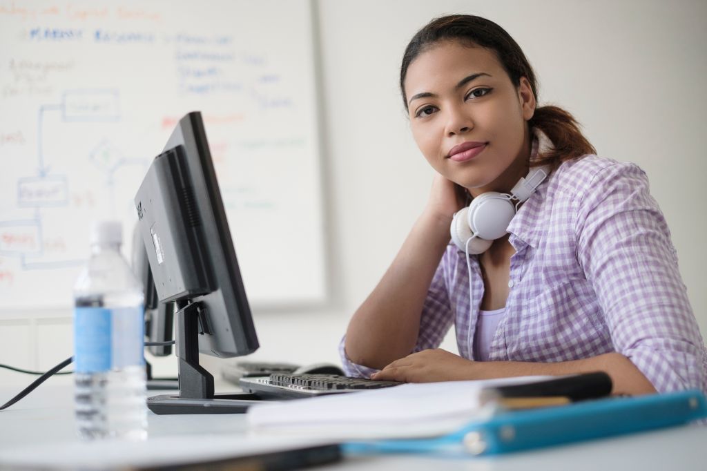 Portrait of smiling Hispanic woman in computer lab