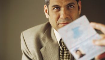 Man's Passport Being Examined
