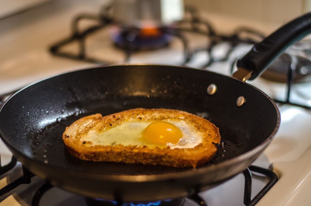 Close-Up Of Egg Yolk In Pan On Stove