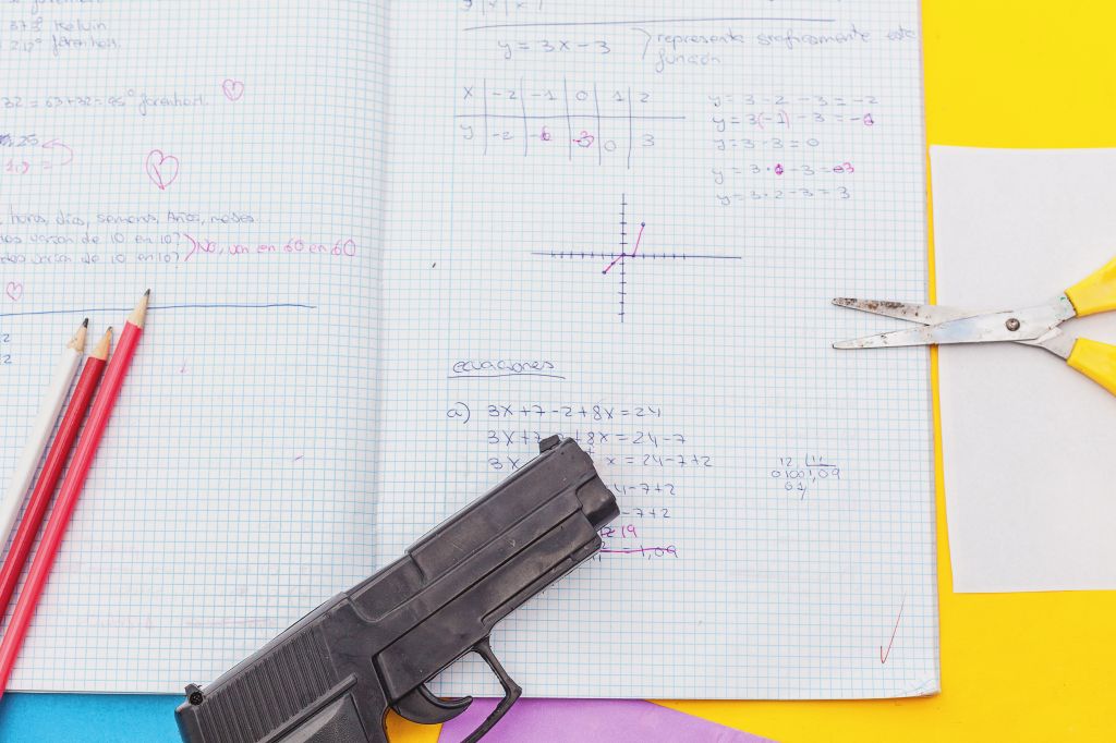 above view student notebook and handgun