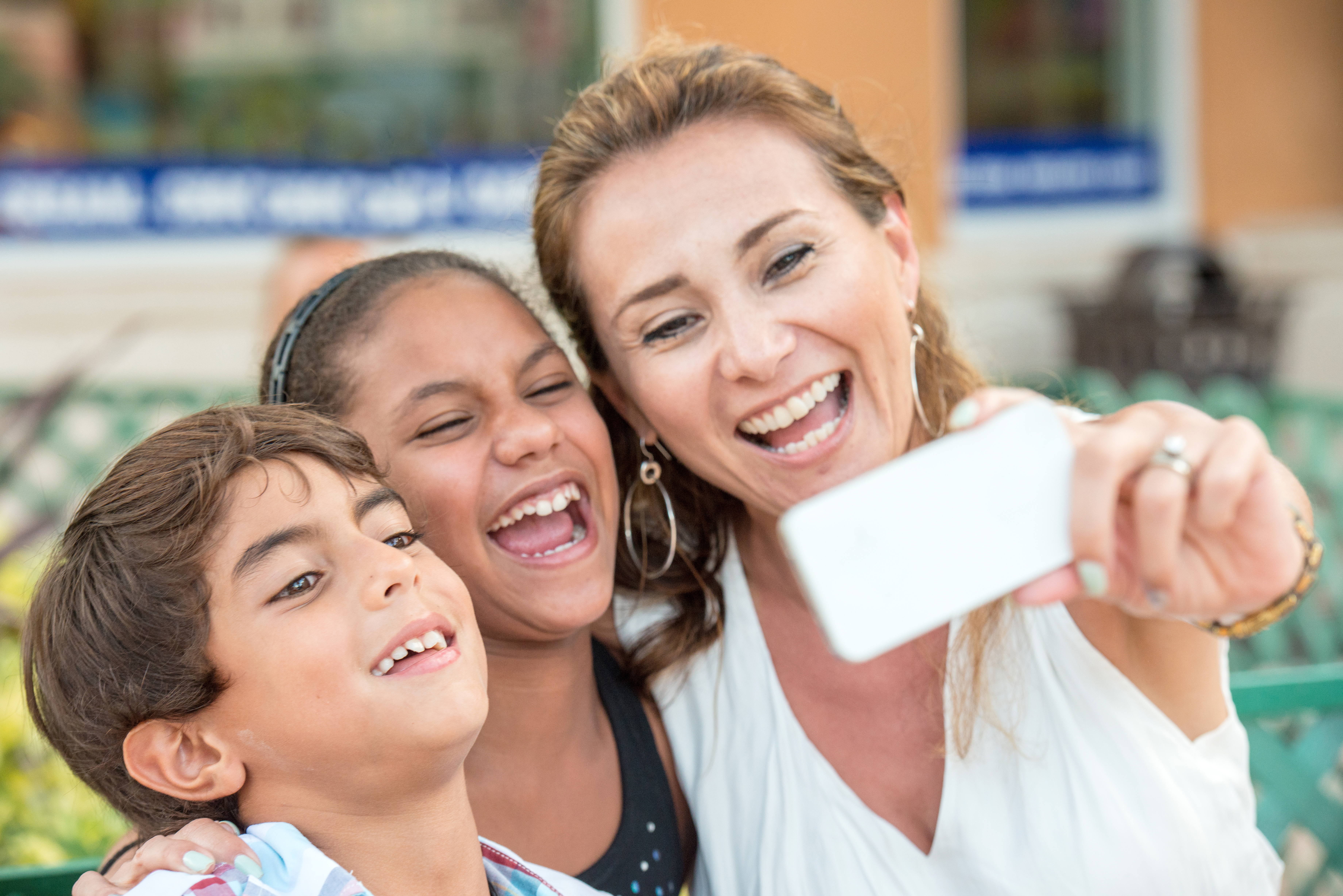 Mature woman posing with her children taking a selfie
