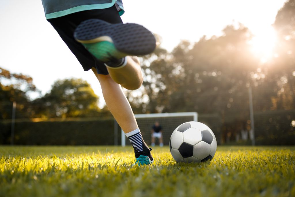Teenager girl playing soccer