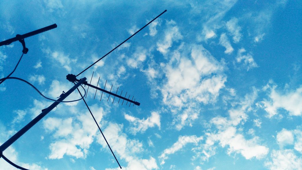 Low Angle View Of Antenna Against Blue Sky