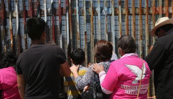 Mexicans Meet Separated Family Members Through U.S.-Mexico Border Fence In Tijuana