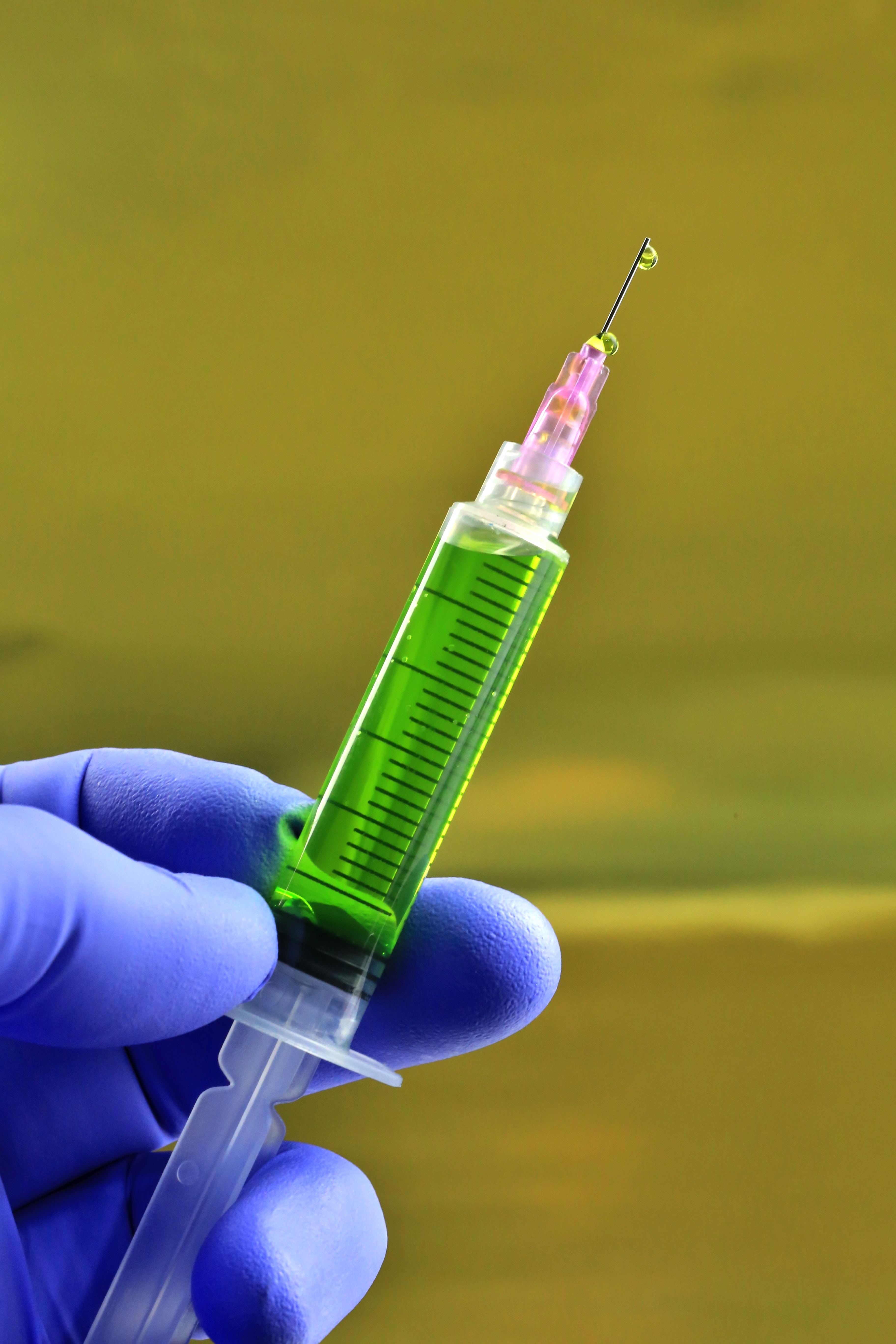 Health worker prepares a Hypodermic needle with Influenza vaccine syringe
