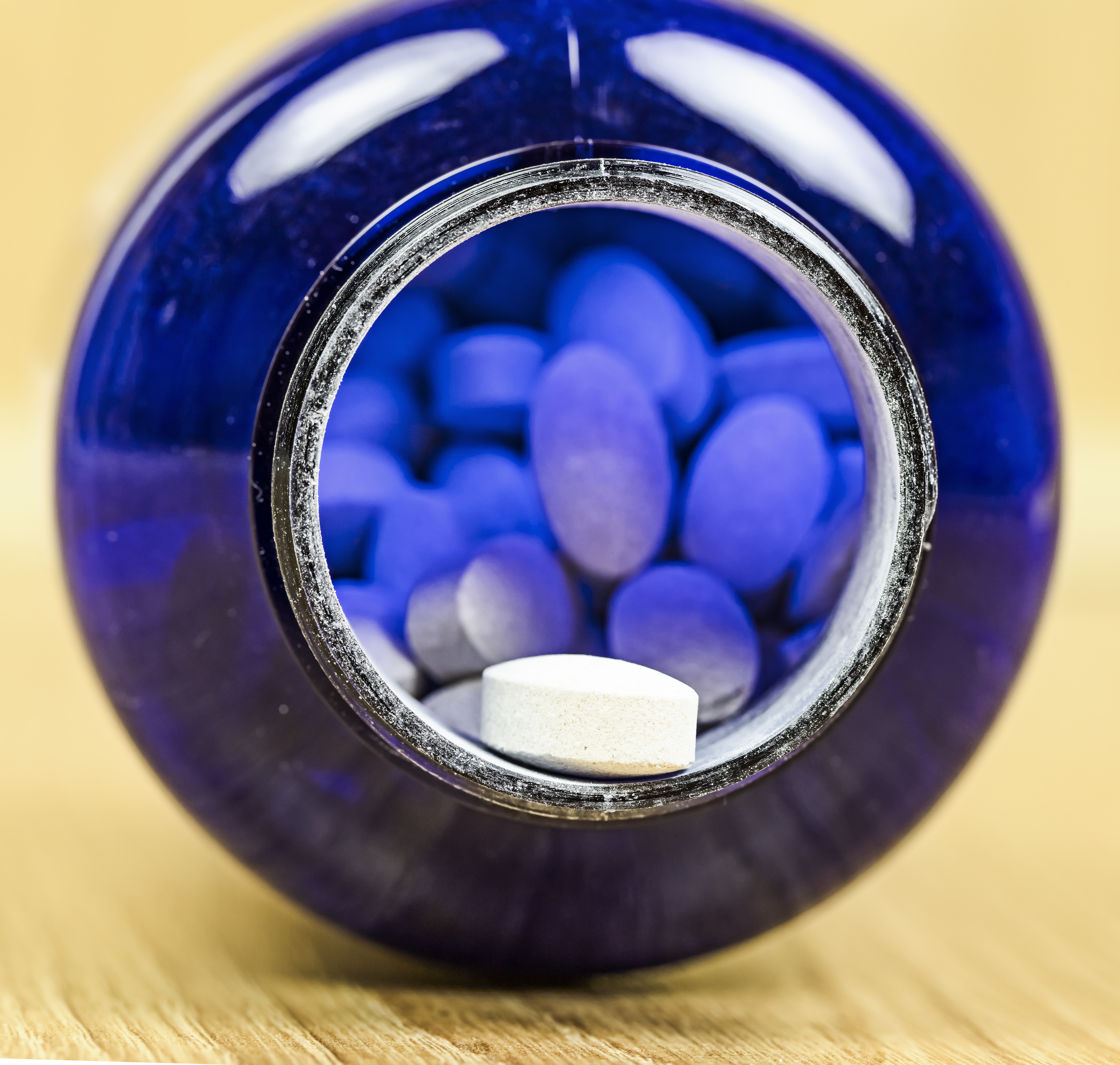 View on a open prescription bottle with assorted pills. Medical concept