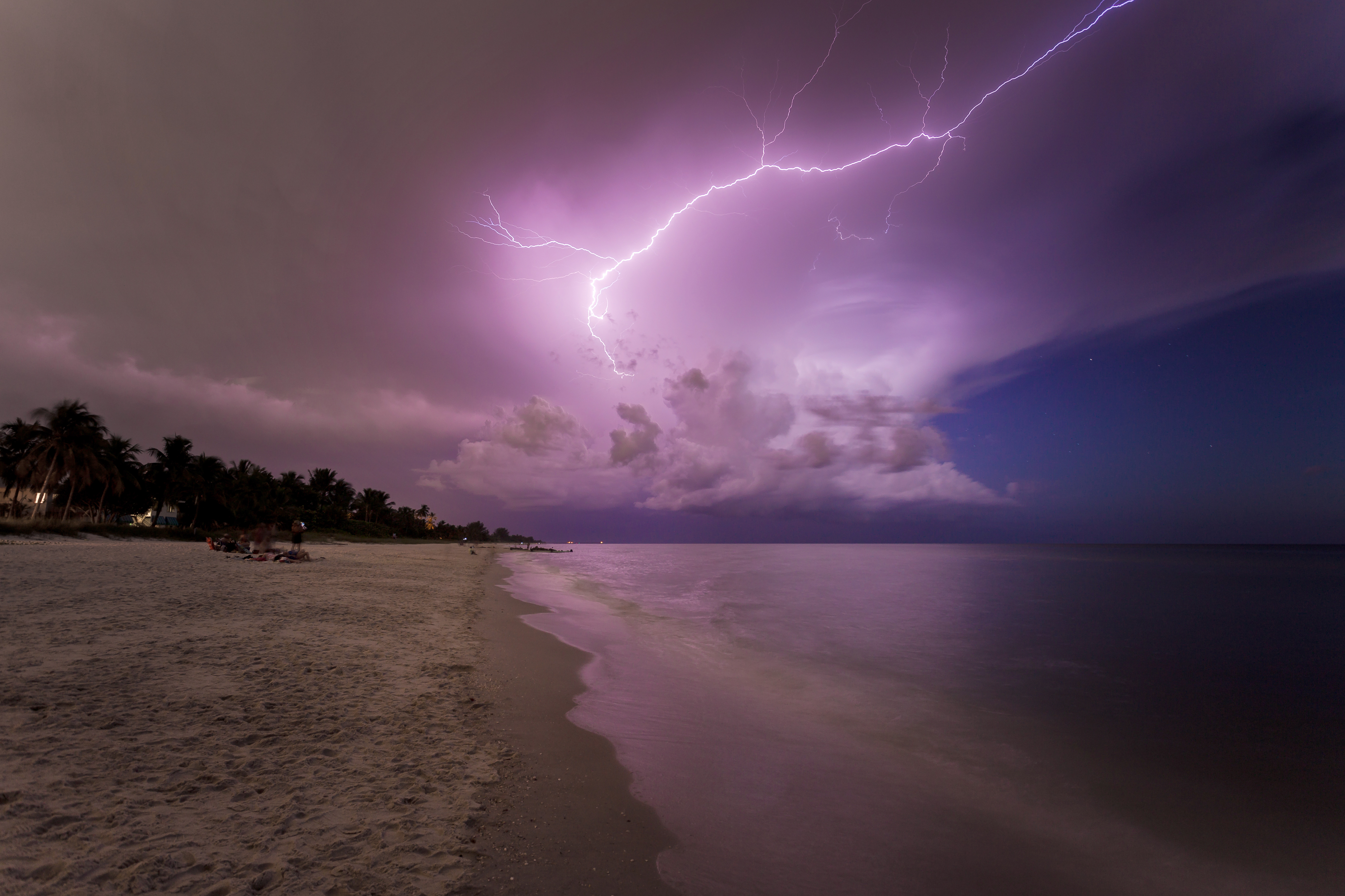 Amazing lightning storm sunset and calmed ocean, at Naples beach, Florida, USA