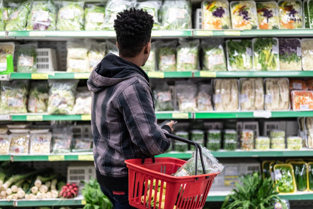 Customer Buying Greens on Supermarket