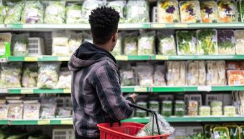 Customer Buying Greens on Supermarket