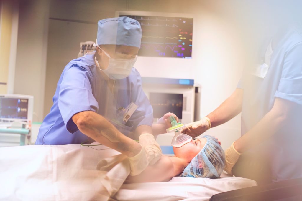 Child with oxygen mask in operating room