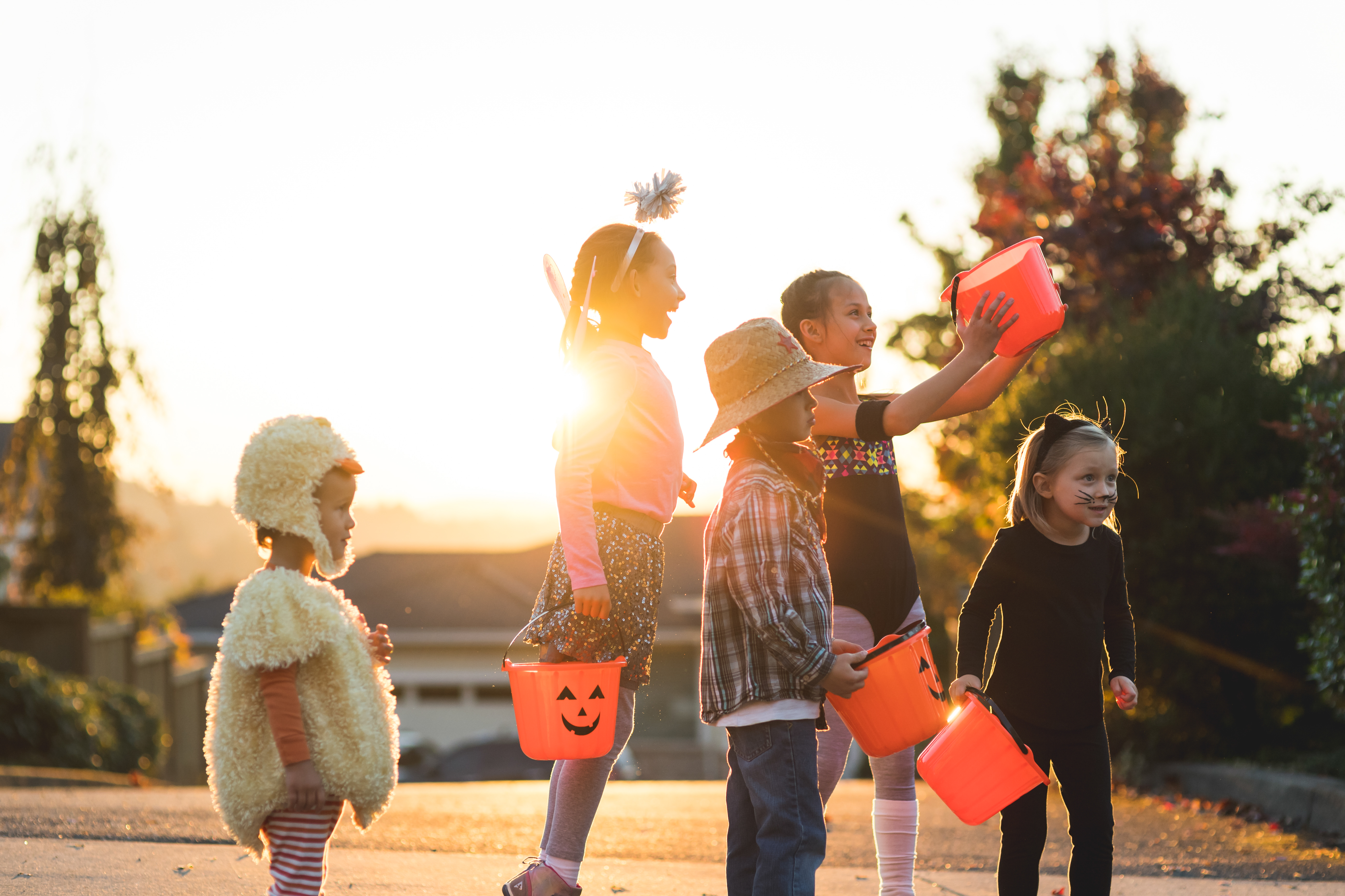 Multiethnic group of kids trick or treating