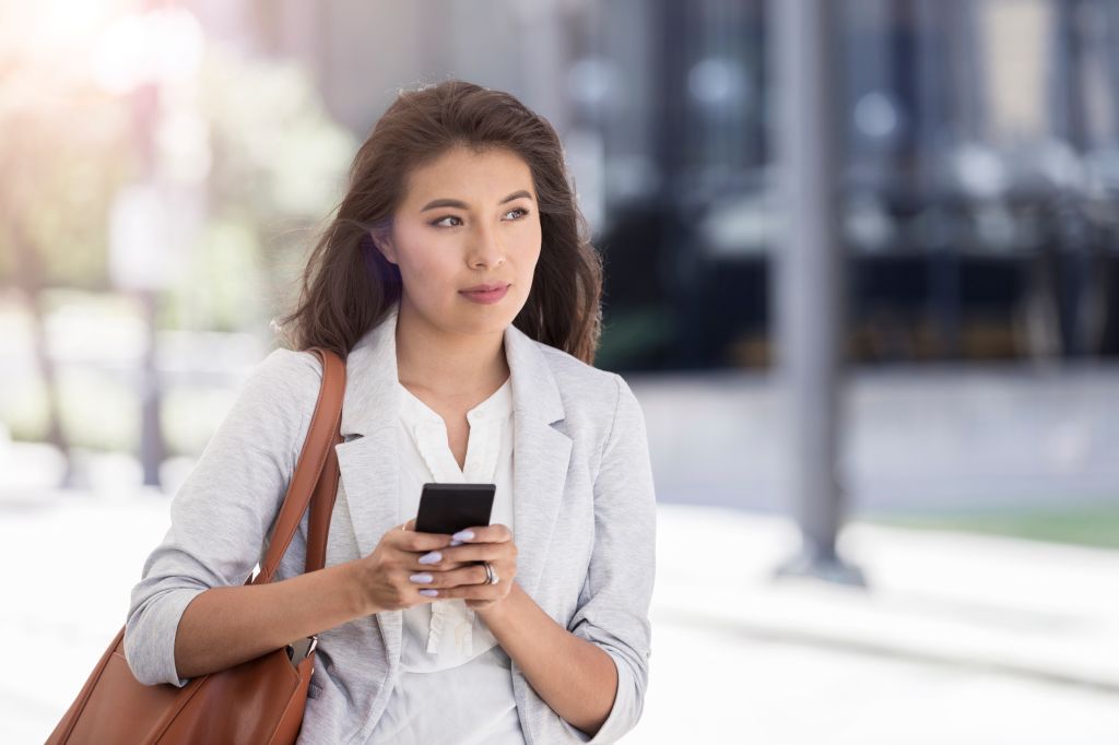 Young woman looks out for ride share ride