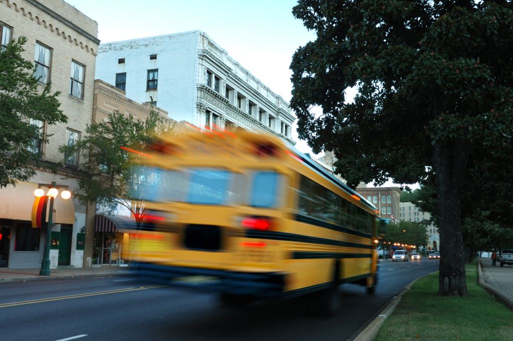 Photo of a moving yellow school bus