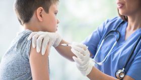 Young Boy Receiving an Immunization Needle stock photo