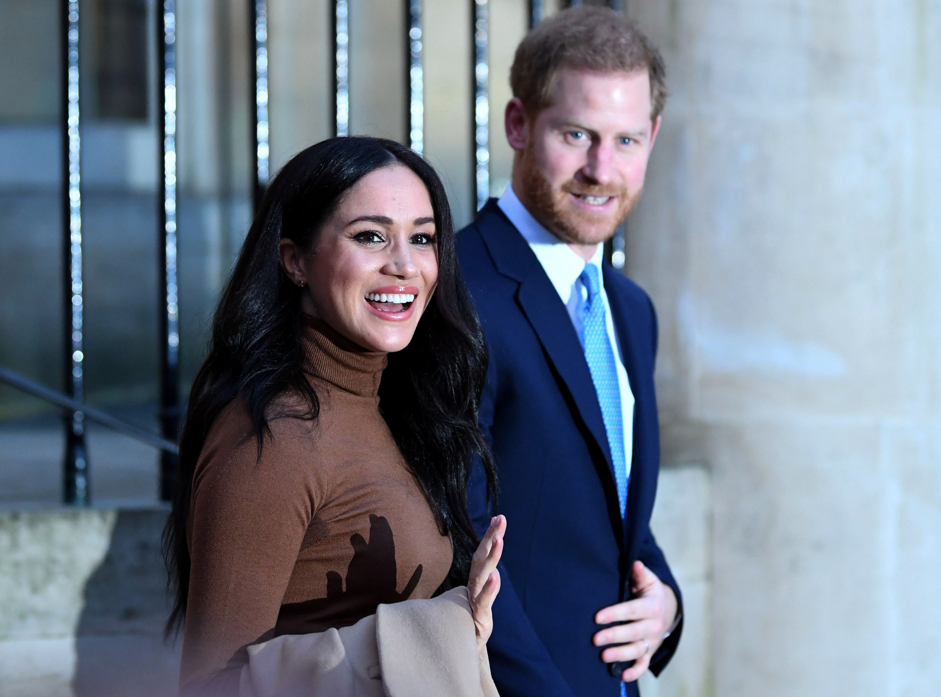 Britain's Prince Harry, Duke of Sussex and Meghan, Duchess of Sussex reacts as they leave after her visit to Canada House in thanks for the warm Canadian hospitality and support they received during their recent stay in Canada, in London on January 7,