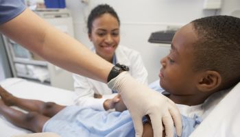 African boy receiving injection at hospital