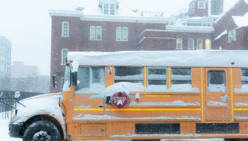 Yellow School Bus Parked on Road in a Snowstorm