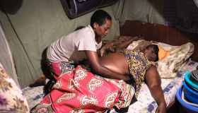 A midwife is seen massaging a pregnant lady in preparation...