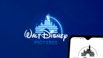 In this photo illustration The Walt Disney Company logo seen...
