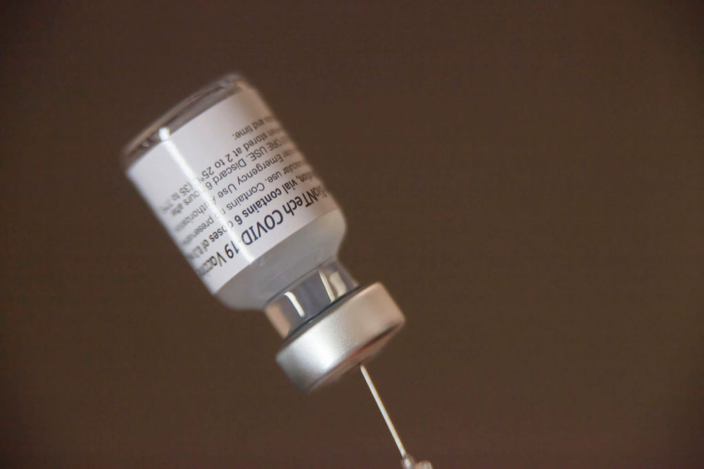 A vaccine vial loaded into a syringe at the mobile clinic on...