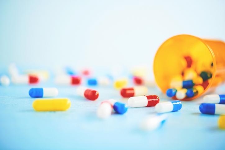 Medical Themed Background with a Variety of Pills on Blue Table