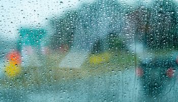 Rain drops on a bus window driving through Boston