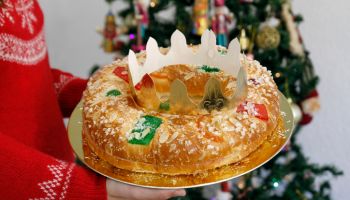 Woman holding Epiphany cake with King Gift