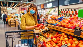 Woman with face mask shopping at supermarket