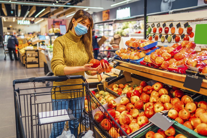 Woman with face mask shopping at supermarket