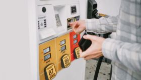 Man Purchases Gas at Pump