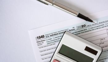 Close Up of Tax Form 1040 and Calculator