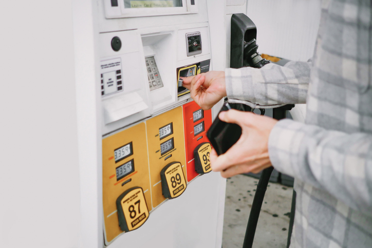 Man Purchases Gas at Pump