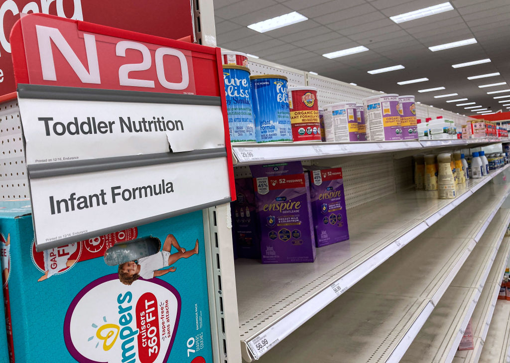 A nearly empty baby formula display shelf is seen at a...