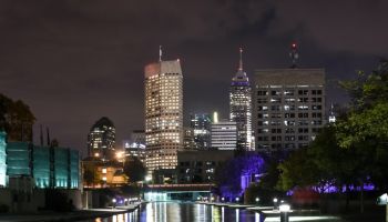 Indianapolis skyline illuminated at night and reflected on White river canal in Indiana, USA