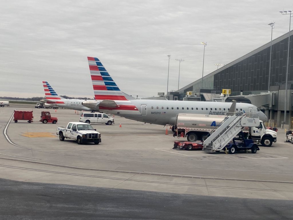 American Airlines airplanes being loaded with baggage before taking off, West Palm Beach Gardens Airport, Florida