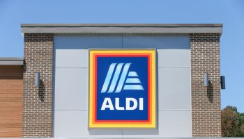 A logo is seen on the outside of an Aldi grocery store...