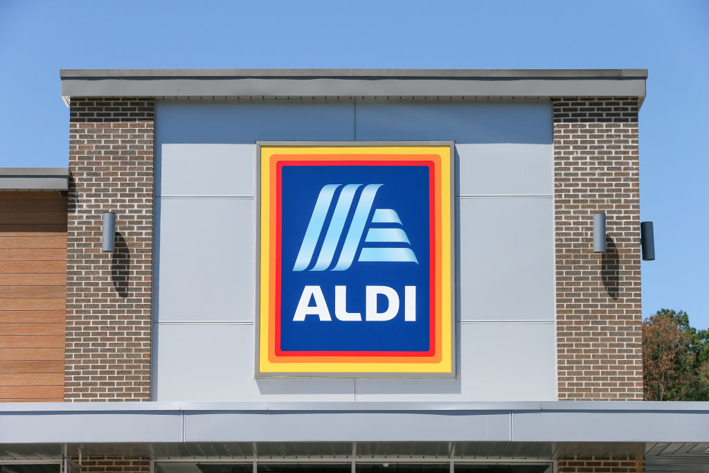 A logo is seen on the outside of an Aldi grocery store...