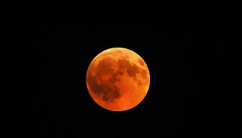 Beautiful shot of a red moon, total lunar eclipse with a black night sky in the background