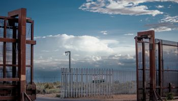 Gate Between United States/Mexico Border Wall Between Sunland Park, New Mexico and Puerto Anapra Chihuahua Mexico Near the Santa Teresa Border Crossing Under a Dramatic Cloudscape Near Dusk